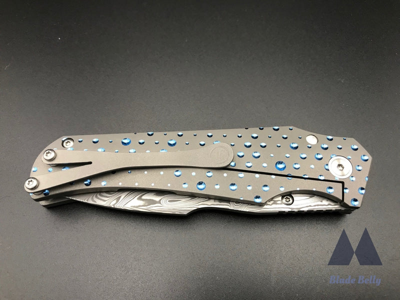 Jason Guthrie Scout - Damasteel Harpoon Drop Point W/ Blue Raindrop Milled Handles (Blade 2019)