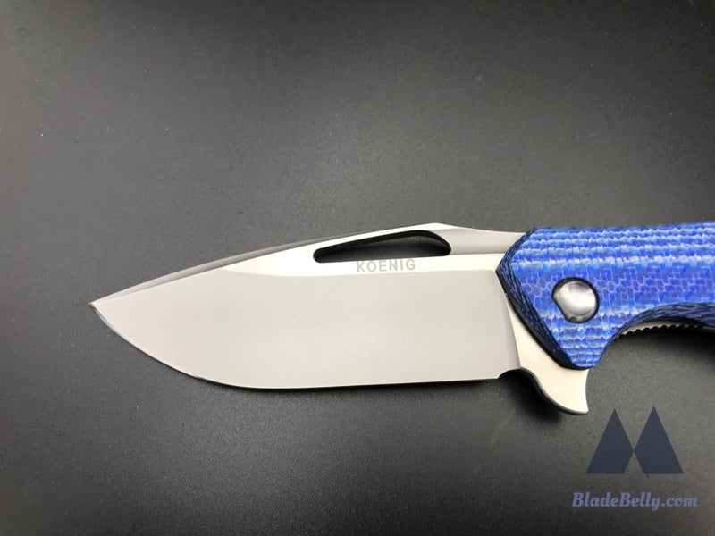 Koenig Arius - Burnished Blade Satin Flats Drop Point Blue Twill Carbon Fiber And Polished Hardware