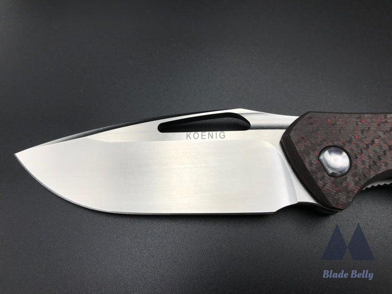 Koenig Arius - Flipper Delete Burnished Drop Point And Red Twill Carbon Fiber